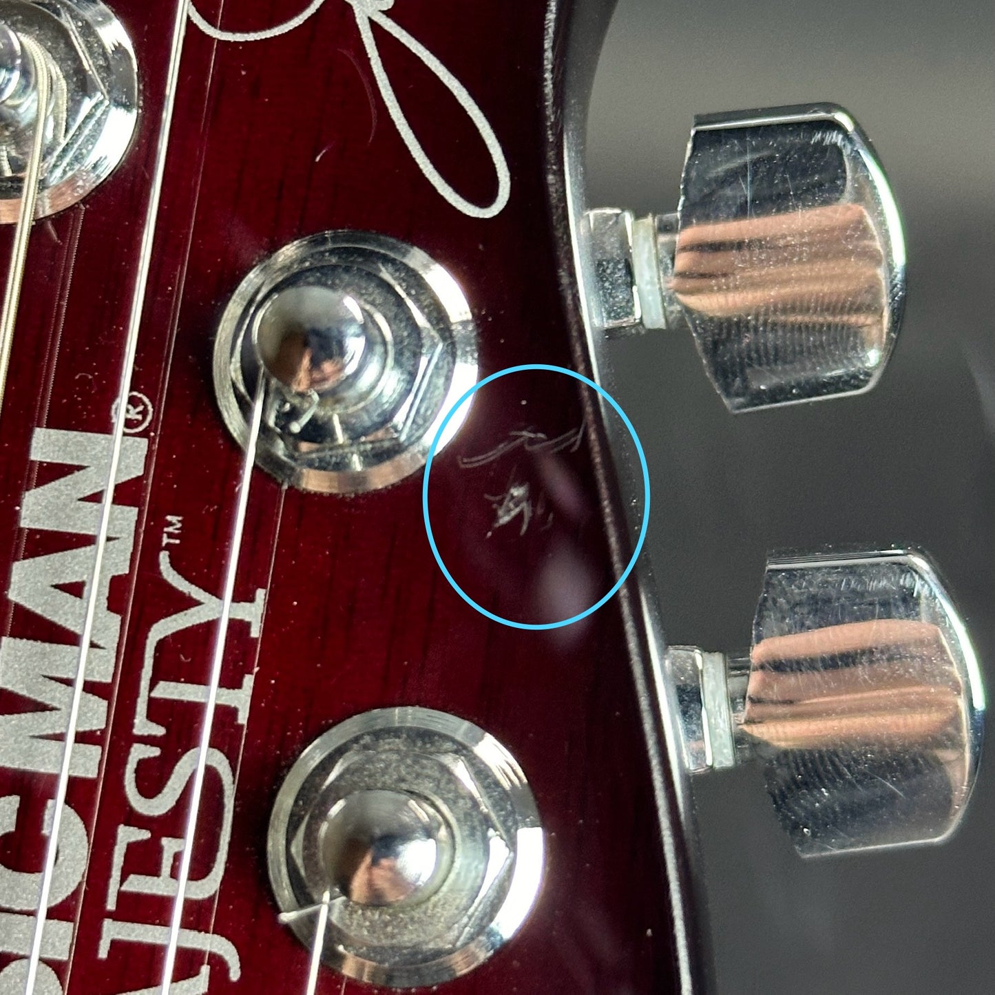 Scratches on front of headstock of Used Ernie Ball Petrucci Monarch Majesty Red.