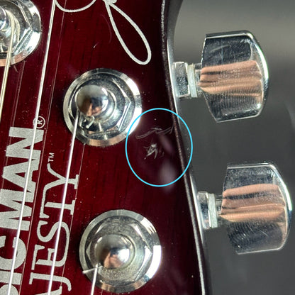 Scratches on front of headstock of Used Ernie Ball Petrucci Monarch Majesty Red.