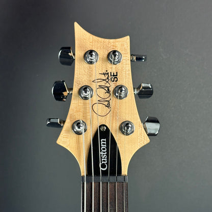 Front of headstock of Used PRS SE Custom 24 Trampas Green.