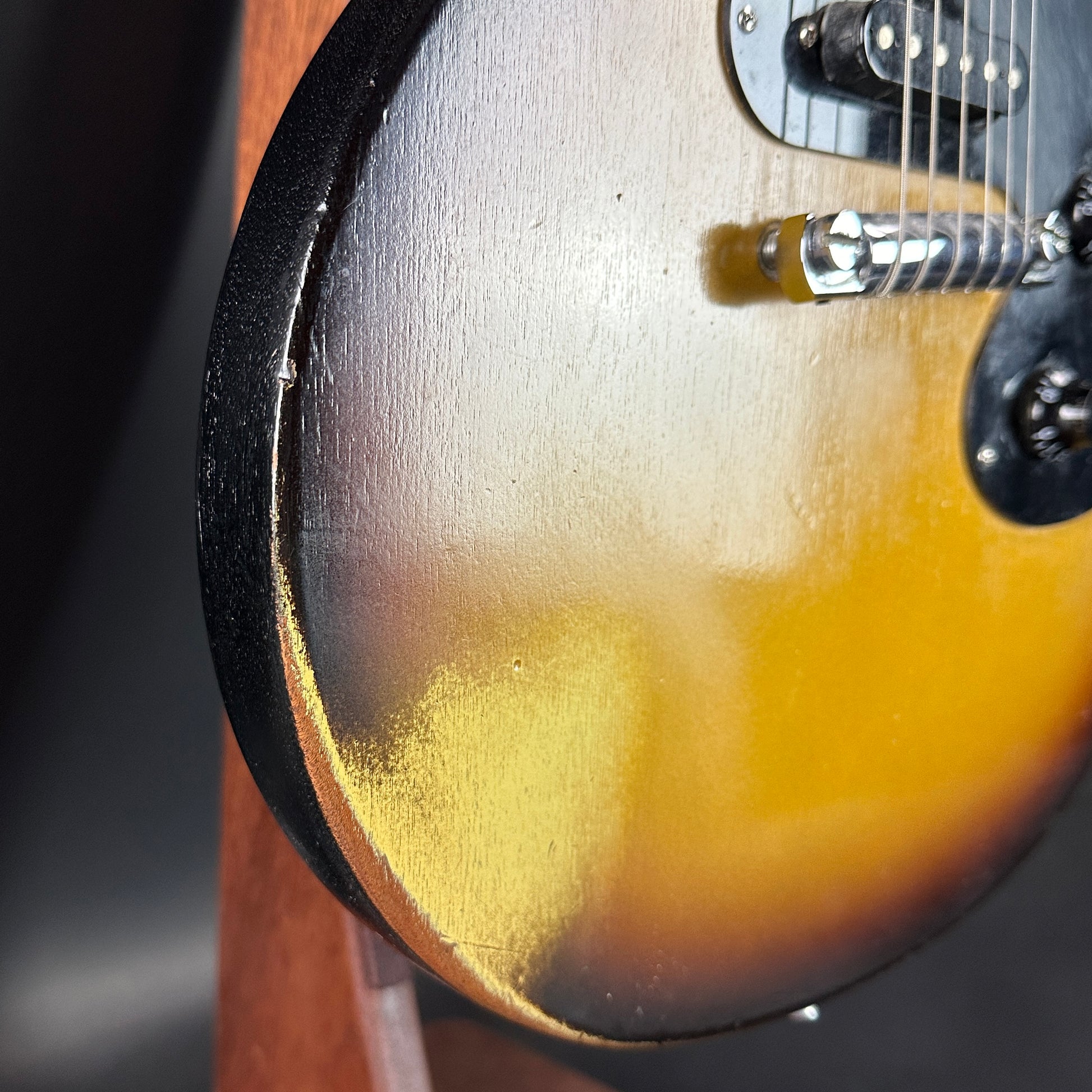 Wear on bottom edge of Used Gibson Melody Maker Sunburst.