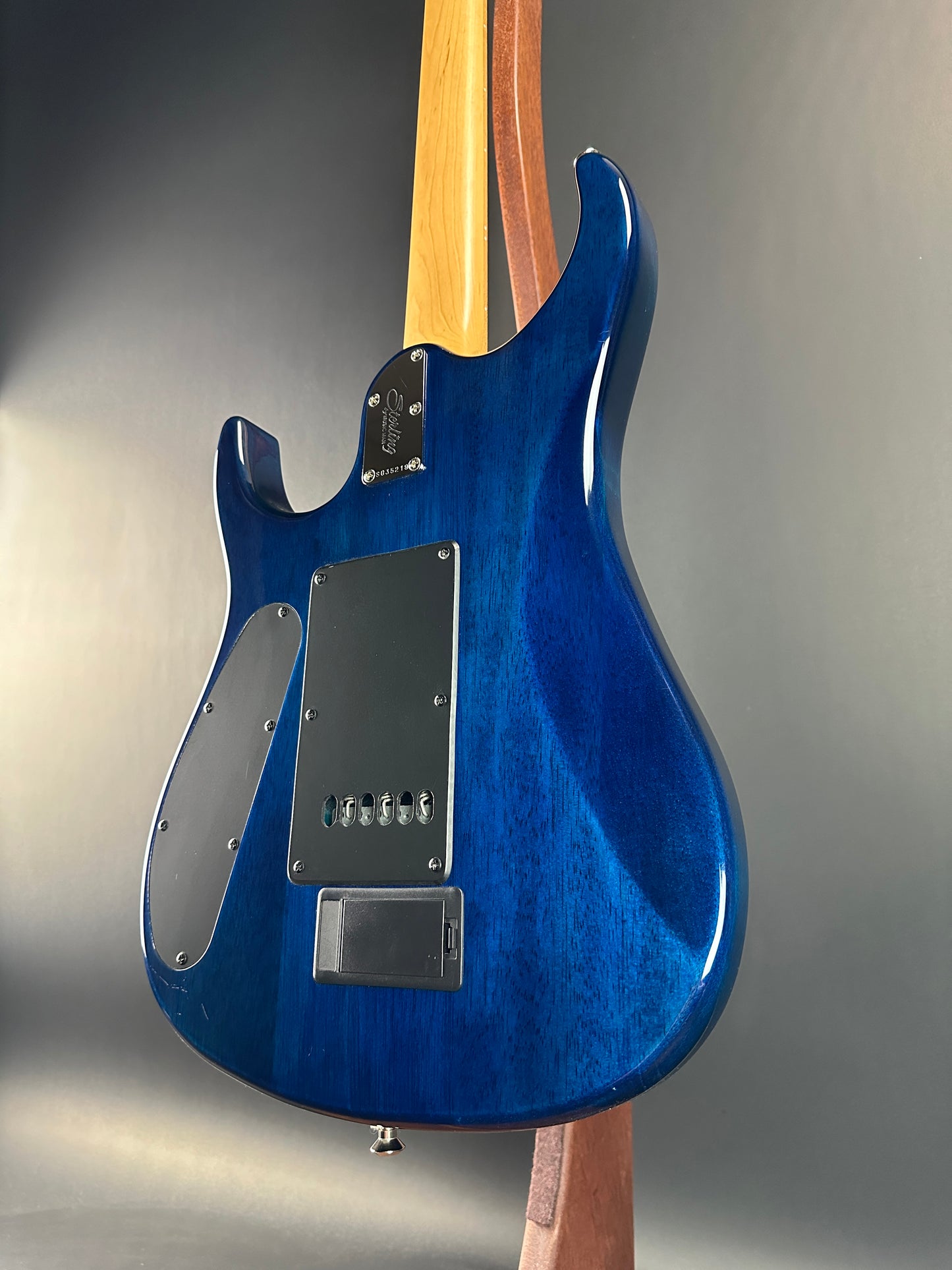 Back angle of Used Sterling by MusicMan John Petrucci Quilt Top Trans Blue.