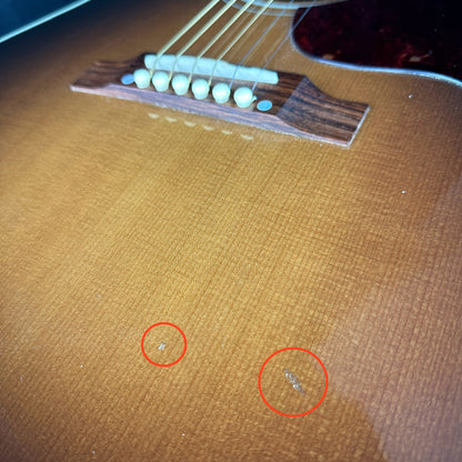 Damage near bridge of Used Gibson Hummingbird Pro.