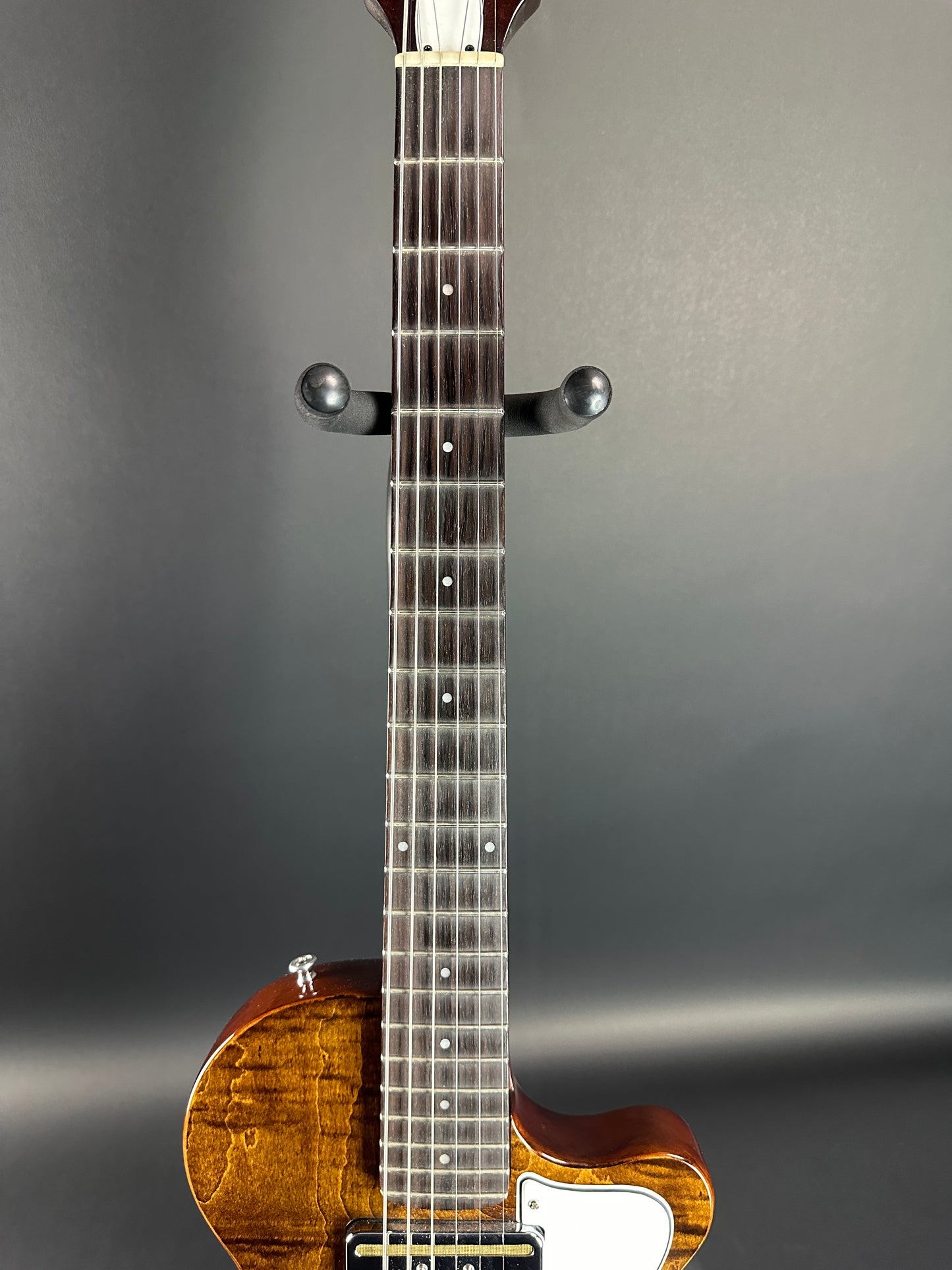 Fretboard of Used Harmony Juno Transparent Brown Flame Maple.