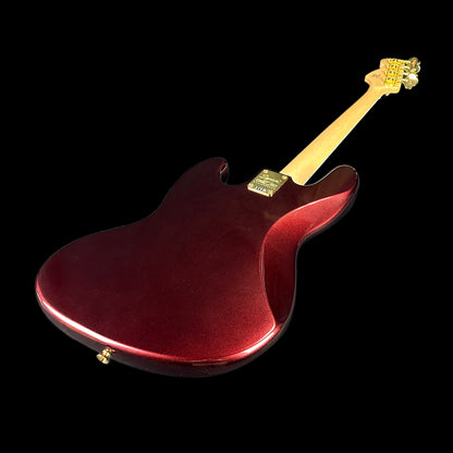 Back angle of Used Squier 40th Anniversary Jazz Bass Ruby Red Metallic.