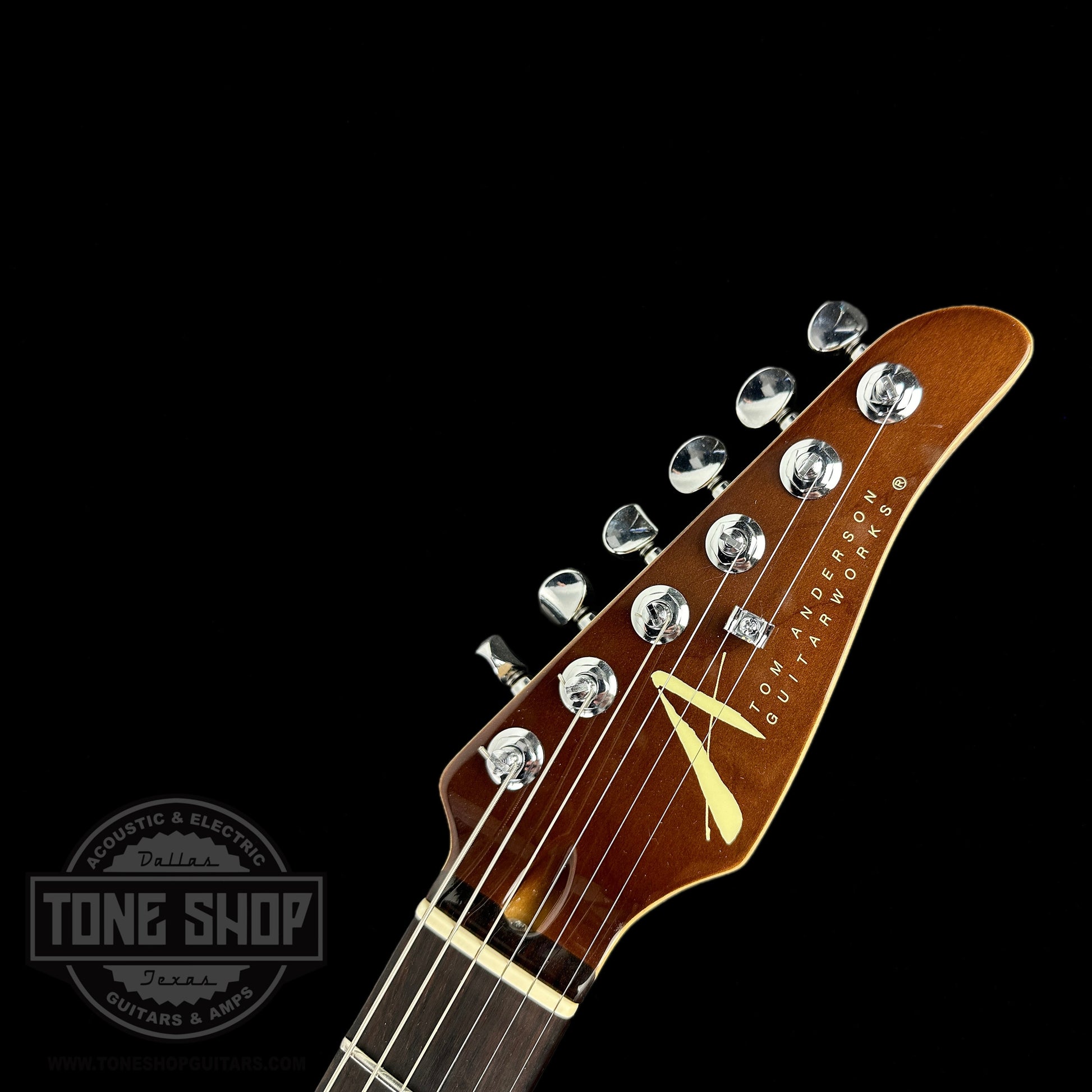 Front of headstock of Used Tom Anderson Hollow T Drop Top Tiger Eye.