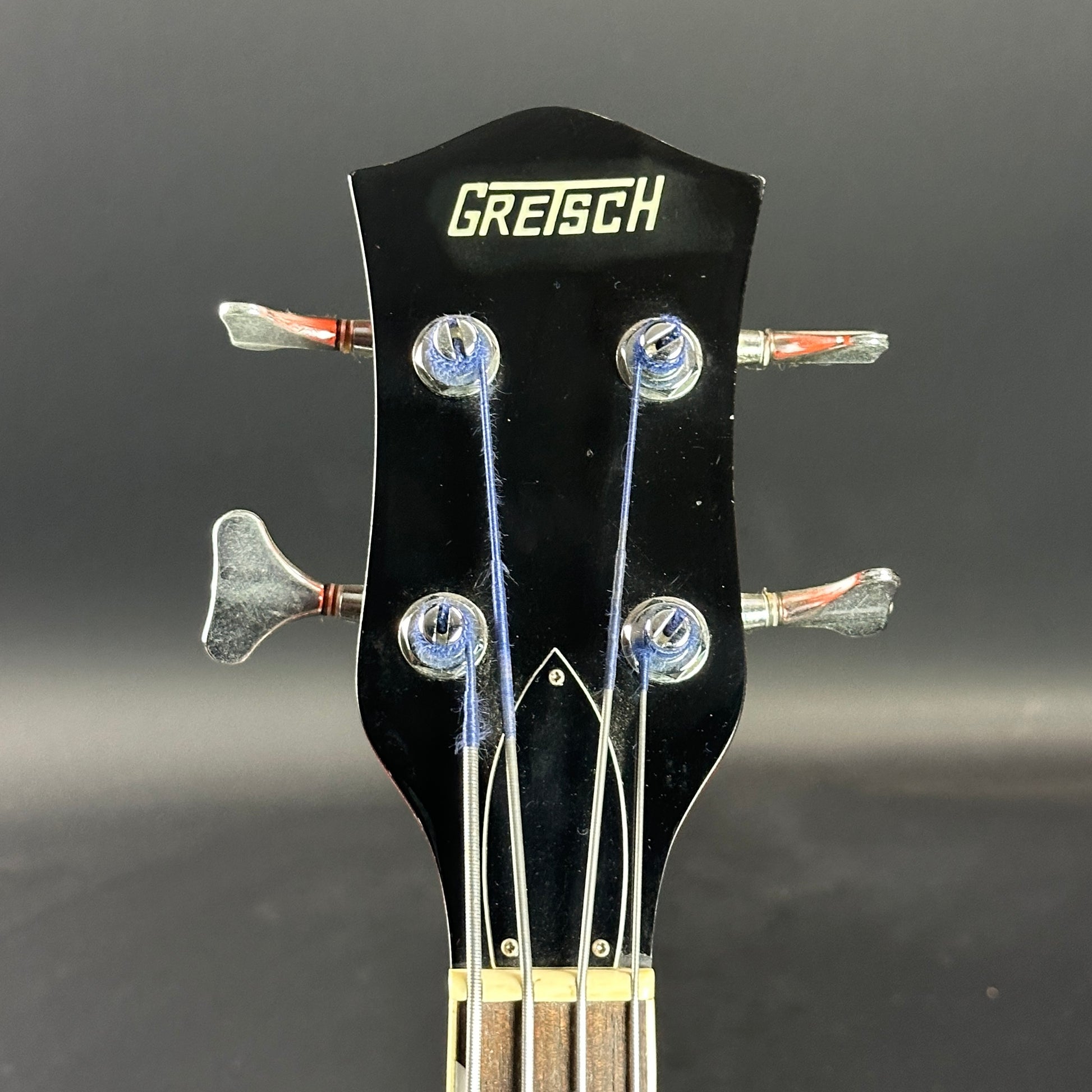 Front of headstock of Used 1991 Gretsch G6119B Broadcaster Bass Orange.