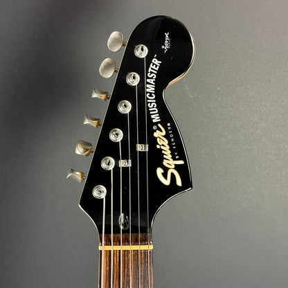 Front of headstock of Used 1999 Squier Vista Musicmaster Black.