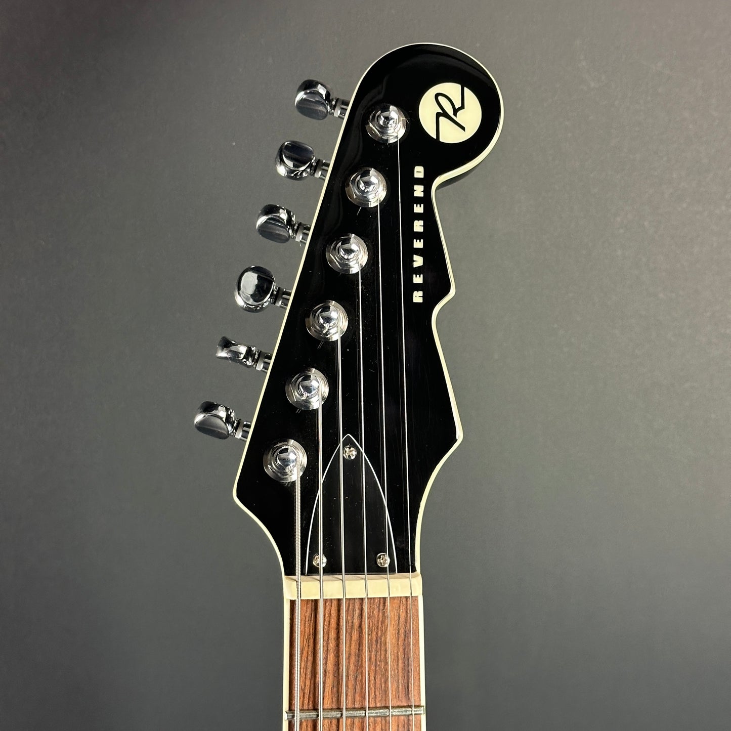 Front of headstock of Used Reverend Warwick DAW Avocado Burst.