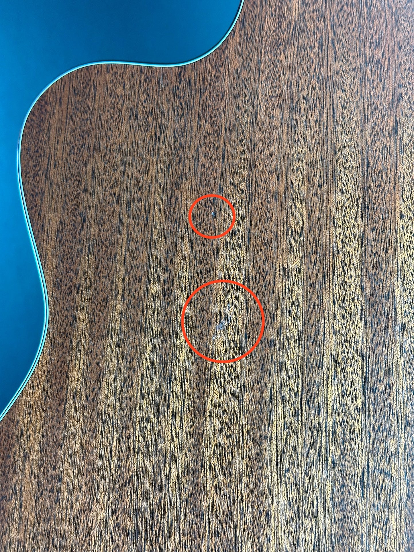 Scratches on back of Used Martin 000C Nylon.