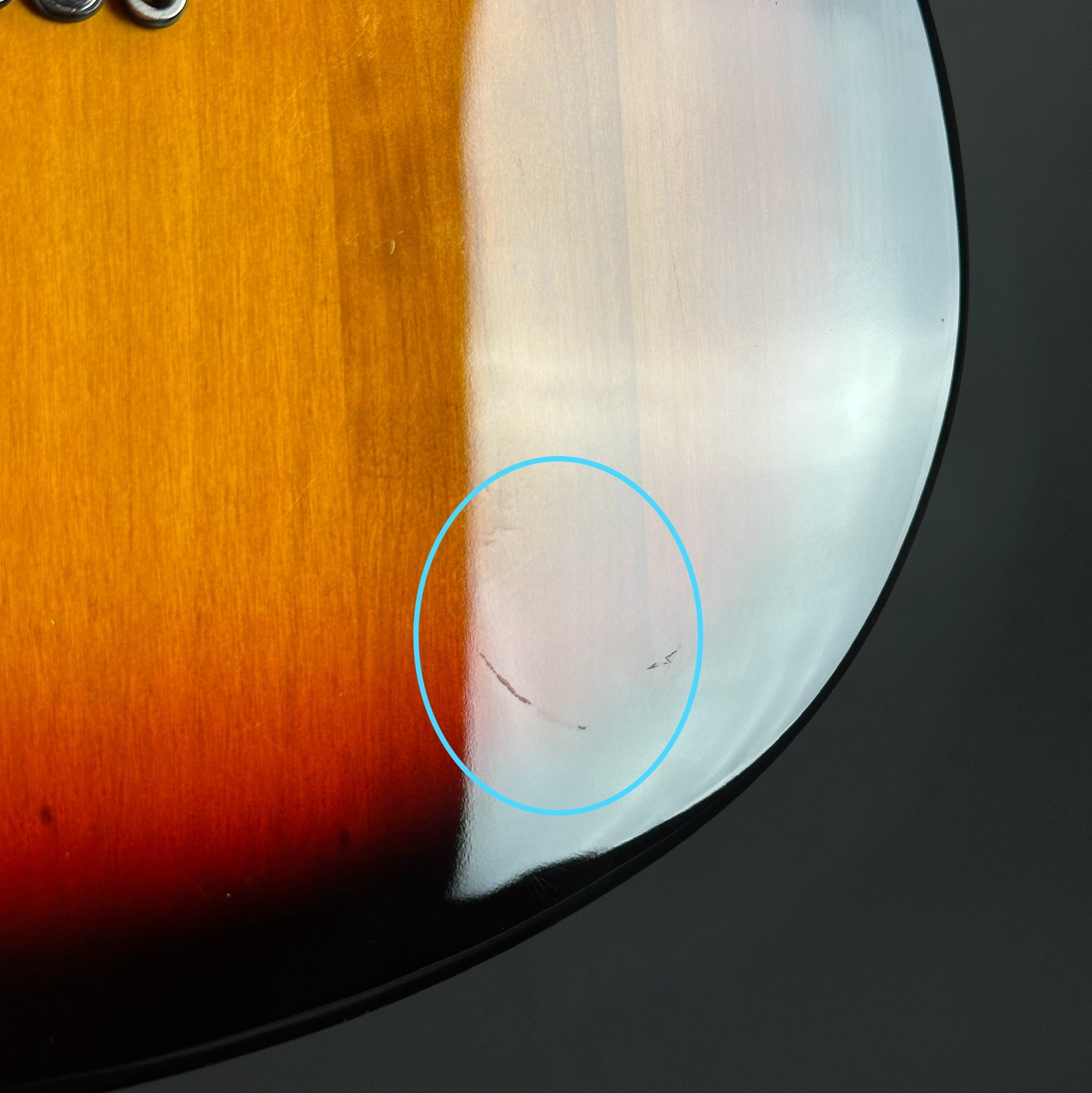 Scratches on back of Used Tagima Model 55 3 Tone Burst.