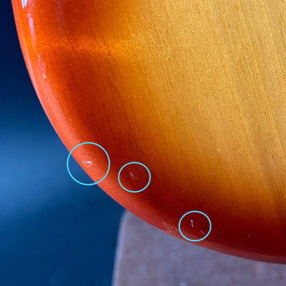 Dings on bottom edge of Used Fender Player Mustang Bass PJ Sienna Sunburst.