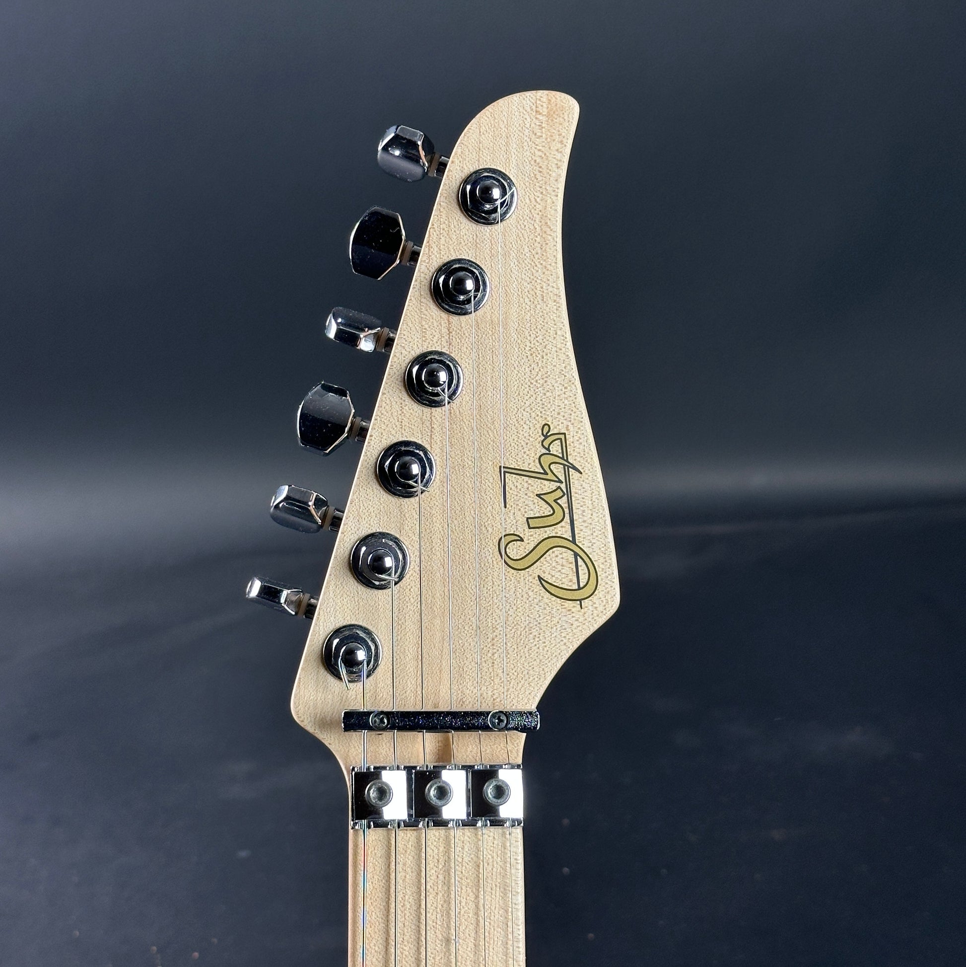 Front of headstock of Used 2015 Suhr Modern Pro Flame Top HSH Floyd Rose.