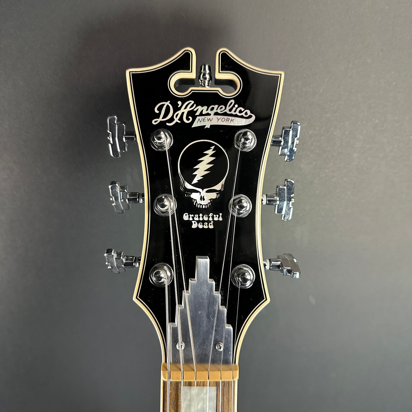 Front of headstock of Used D'Angelico Premier Grateful Dead DC Semi-Hollow.