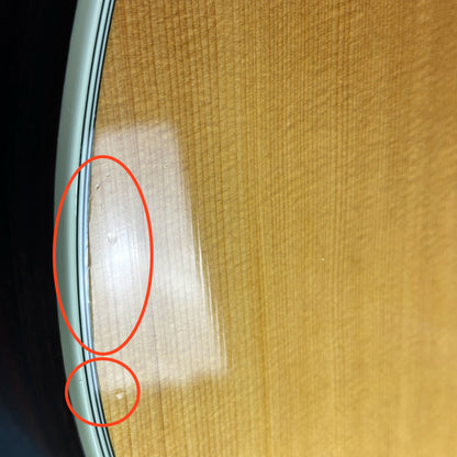 Damage on side edge of Used Taylor 814ce Natural.