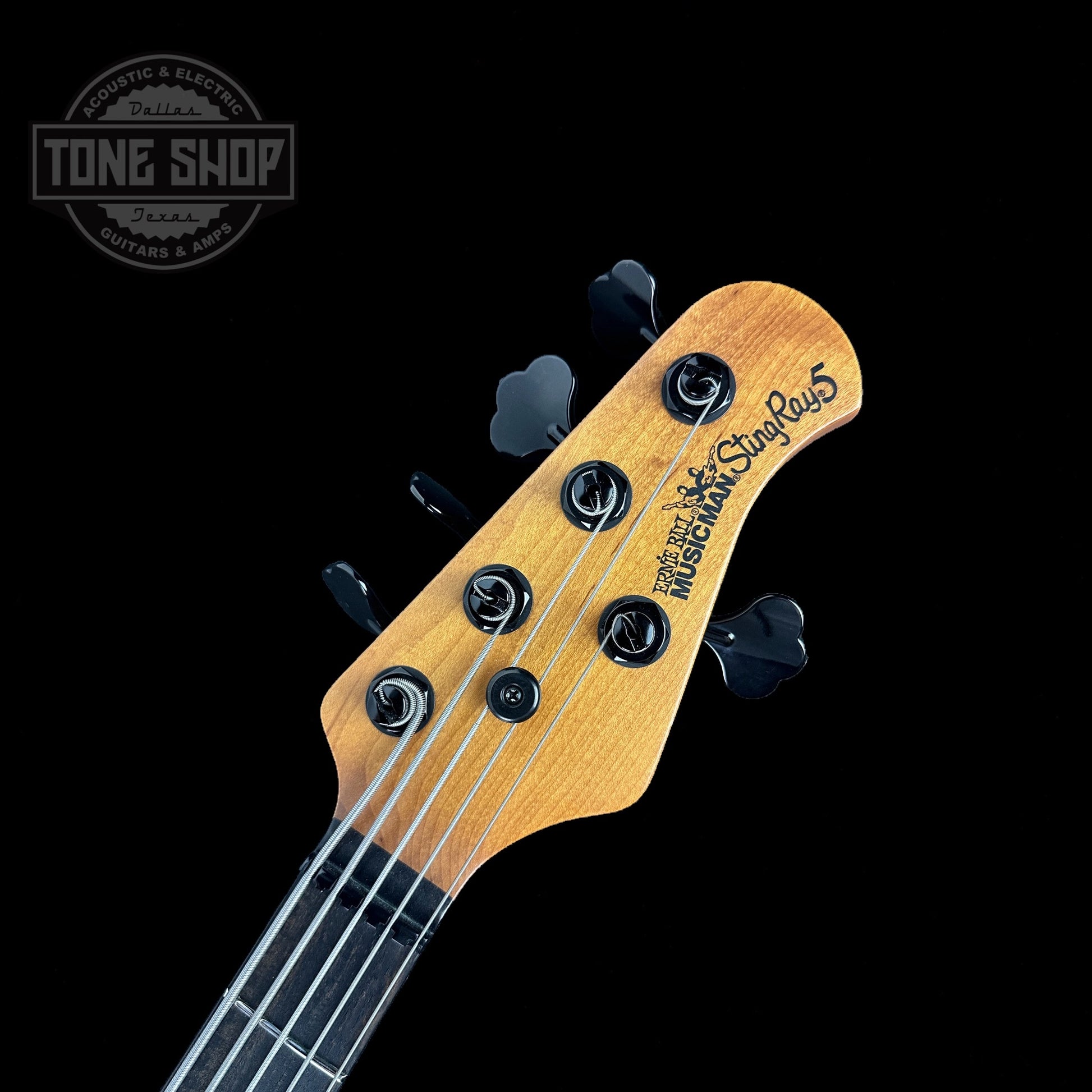 Front of headstock of Used Ernie Ball Musicman Stingray 5 HH Charcoal Sparkle.