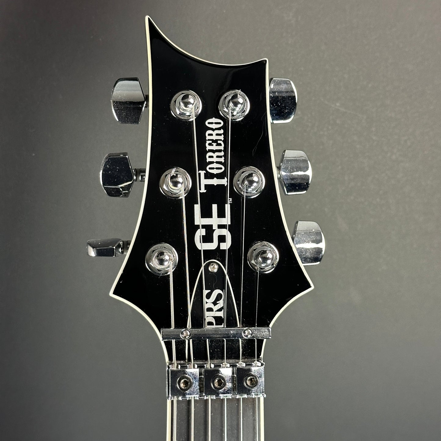 Front of headstock of Used PRS SE Torero Sapphire.