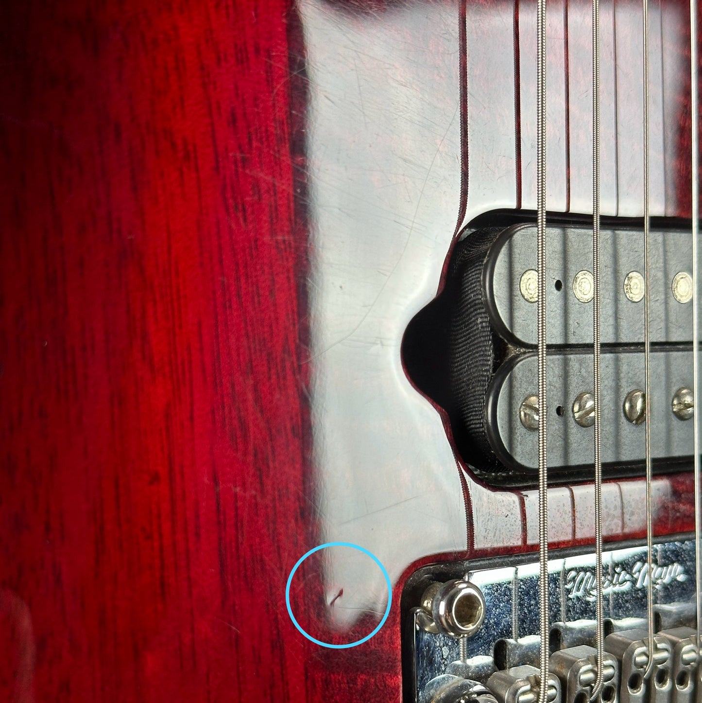 Ding near bridge of Used Ernie Ball Petrucci Monarch Majesty Red.