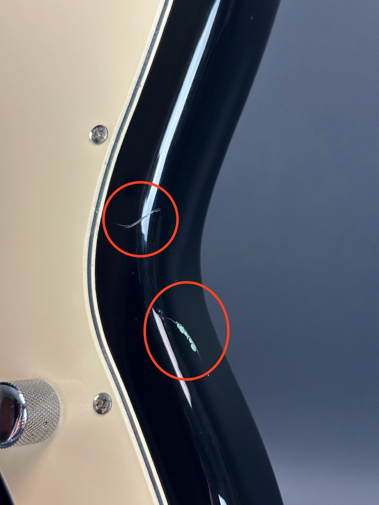 Damage on side of Used 1999 Squier Vista Musicmaster Black.