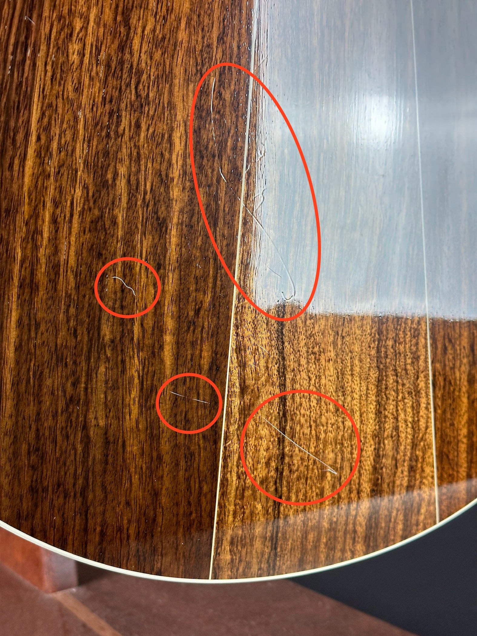 Scratches on back of Used Taylor 815ce.