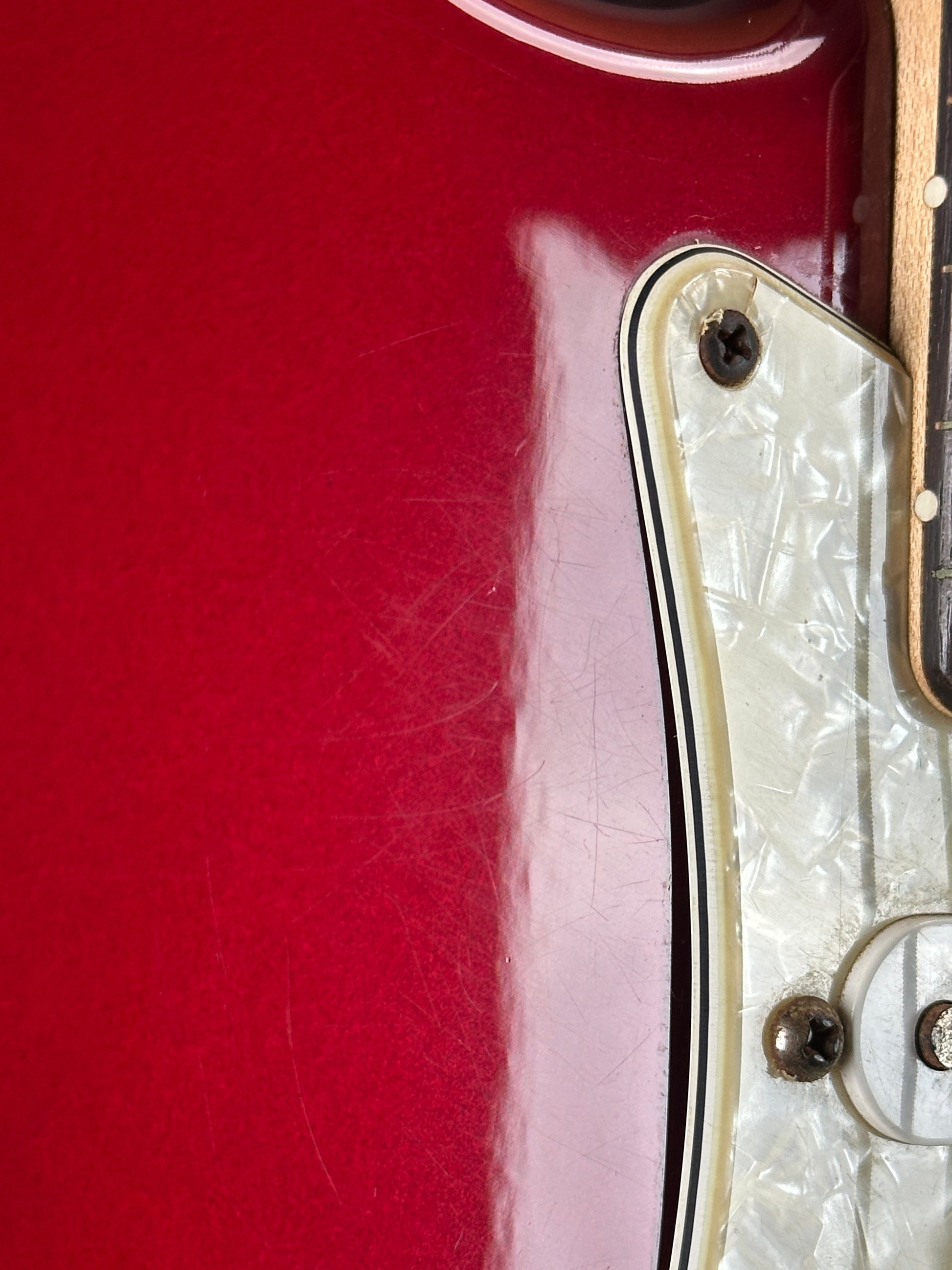 Scratches near pickguard of Used 2006 Fender Sam Ash 48th Street Red Strat.