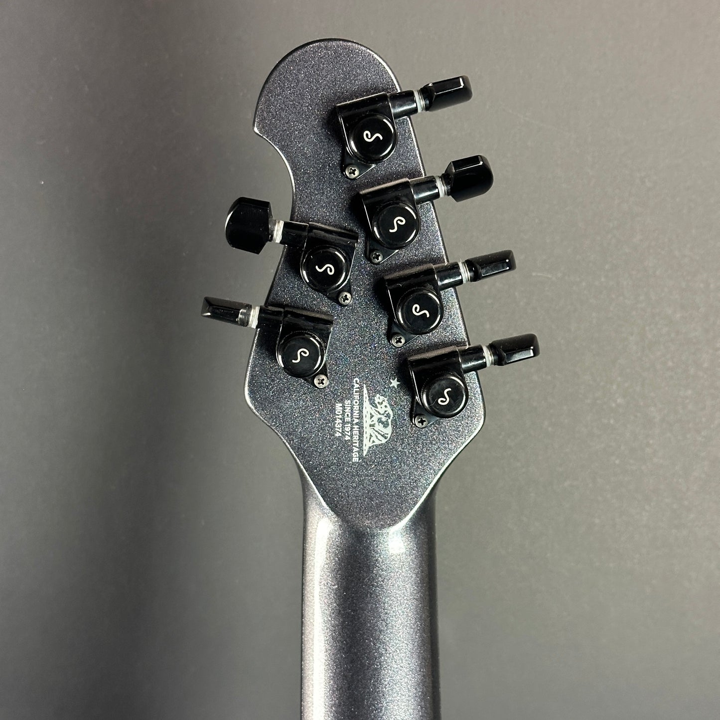 Back of headstock of Used Ernie Ball Musicman Majesty 6 John Petrucci Smoked Pearl.