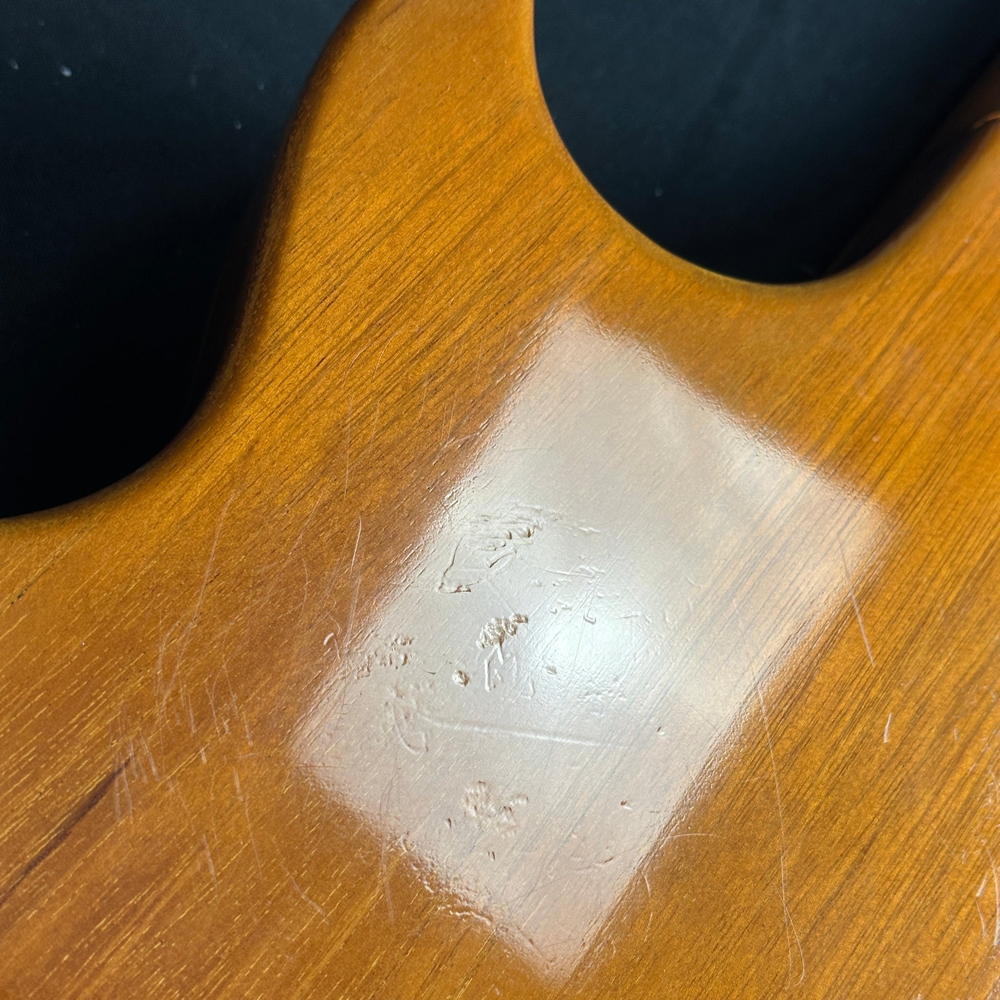 Scratches on back of body of Used Gibson Custom 1957 Les Paul Gold Top.