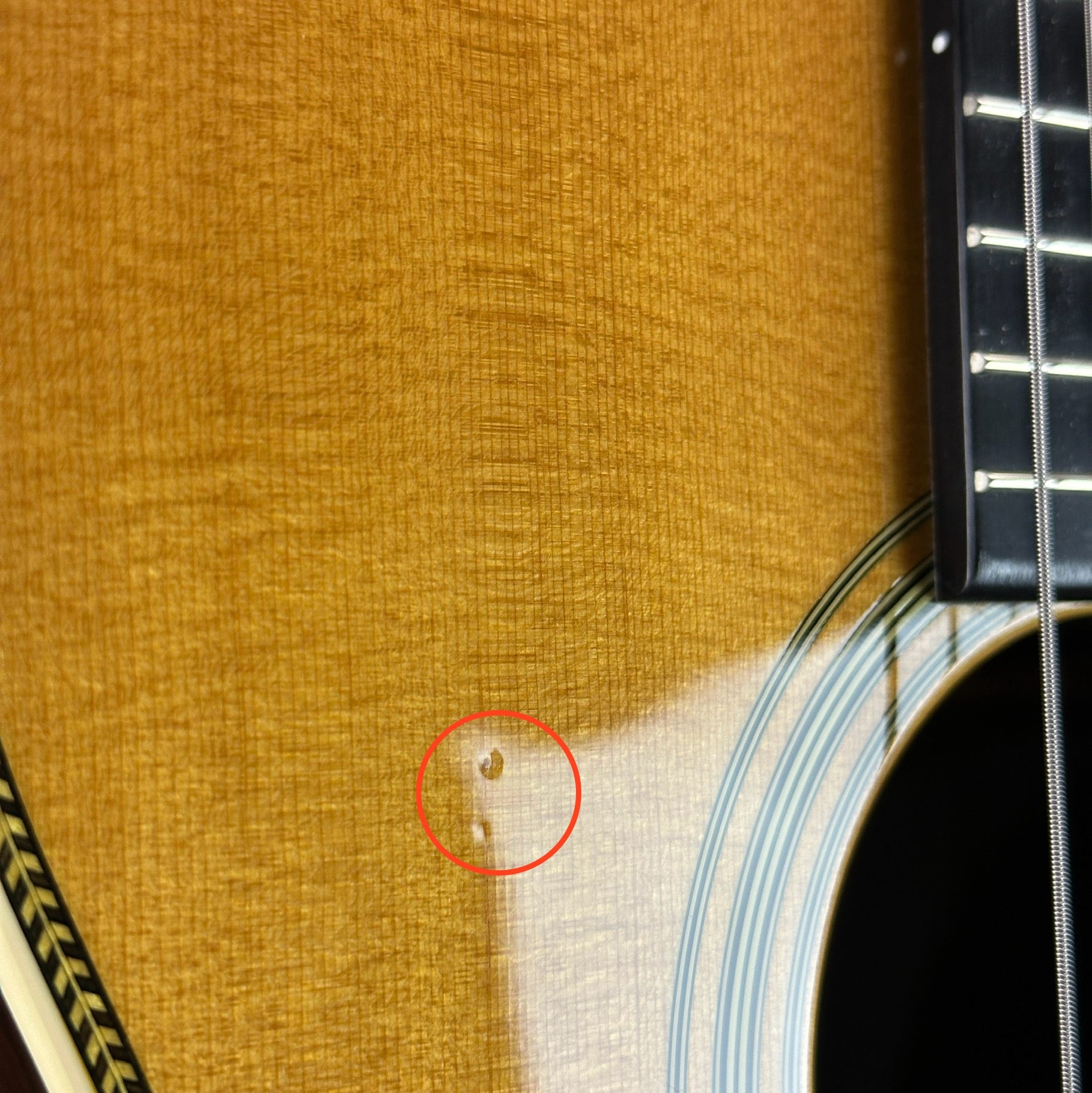 Dings near soundhole of Used Martin 00-28 Natural.