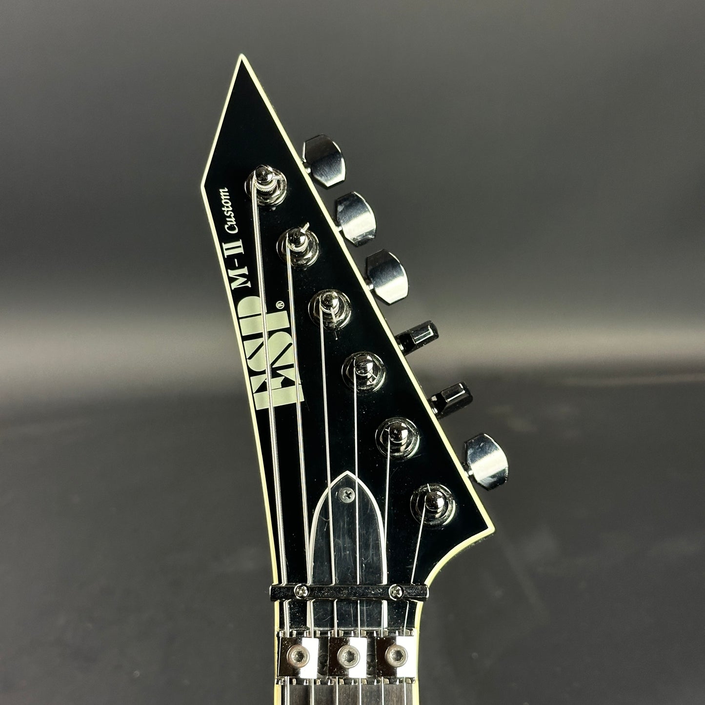 Front of headstock of Used ESP M-11 Custom Black.