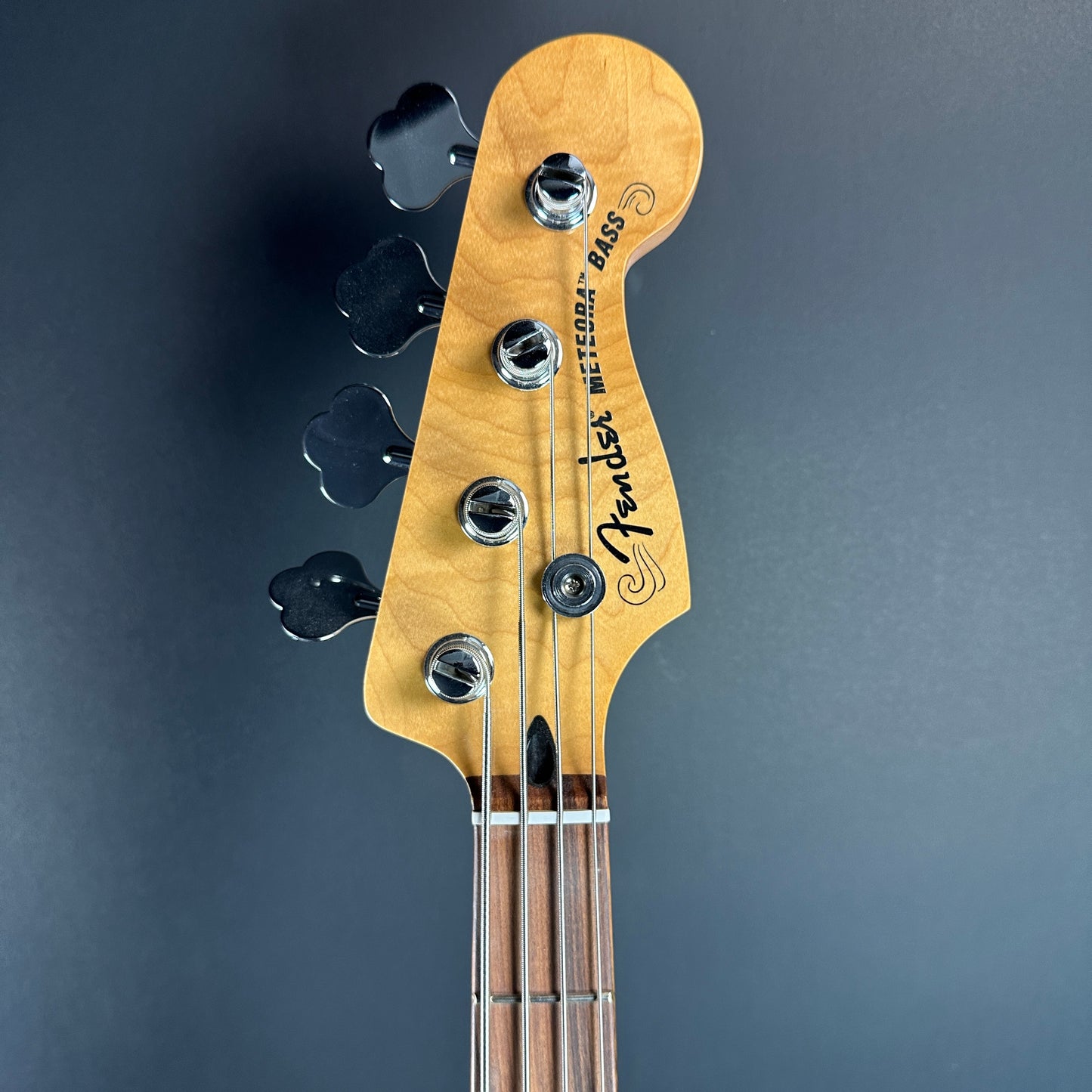 Front of headstock of Used Fender Player Plus Meteora Bass Tequila Sunrise.