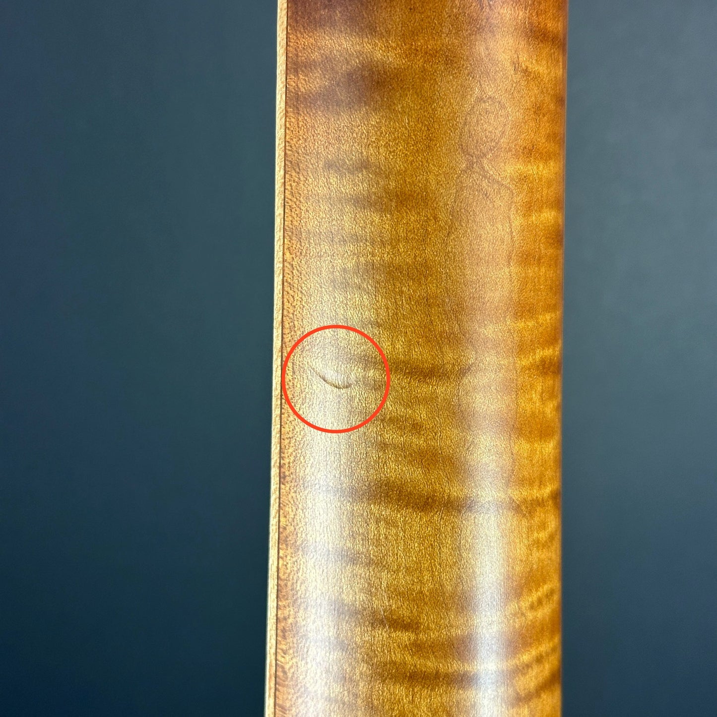 Scratch on back of neck of Used Mule Resonator Guitar.