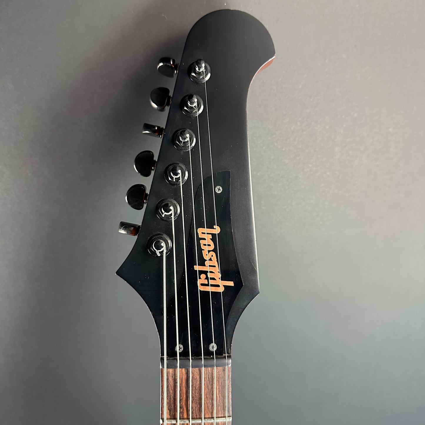 Front of headstock of Used Gibson Non-Reverse Firebird Limited Edition Vintage Copper.