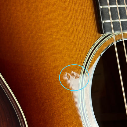 Two dings near soundhole of Used Taylor 512ce Ltd Koa/Cedar 12 Fret.