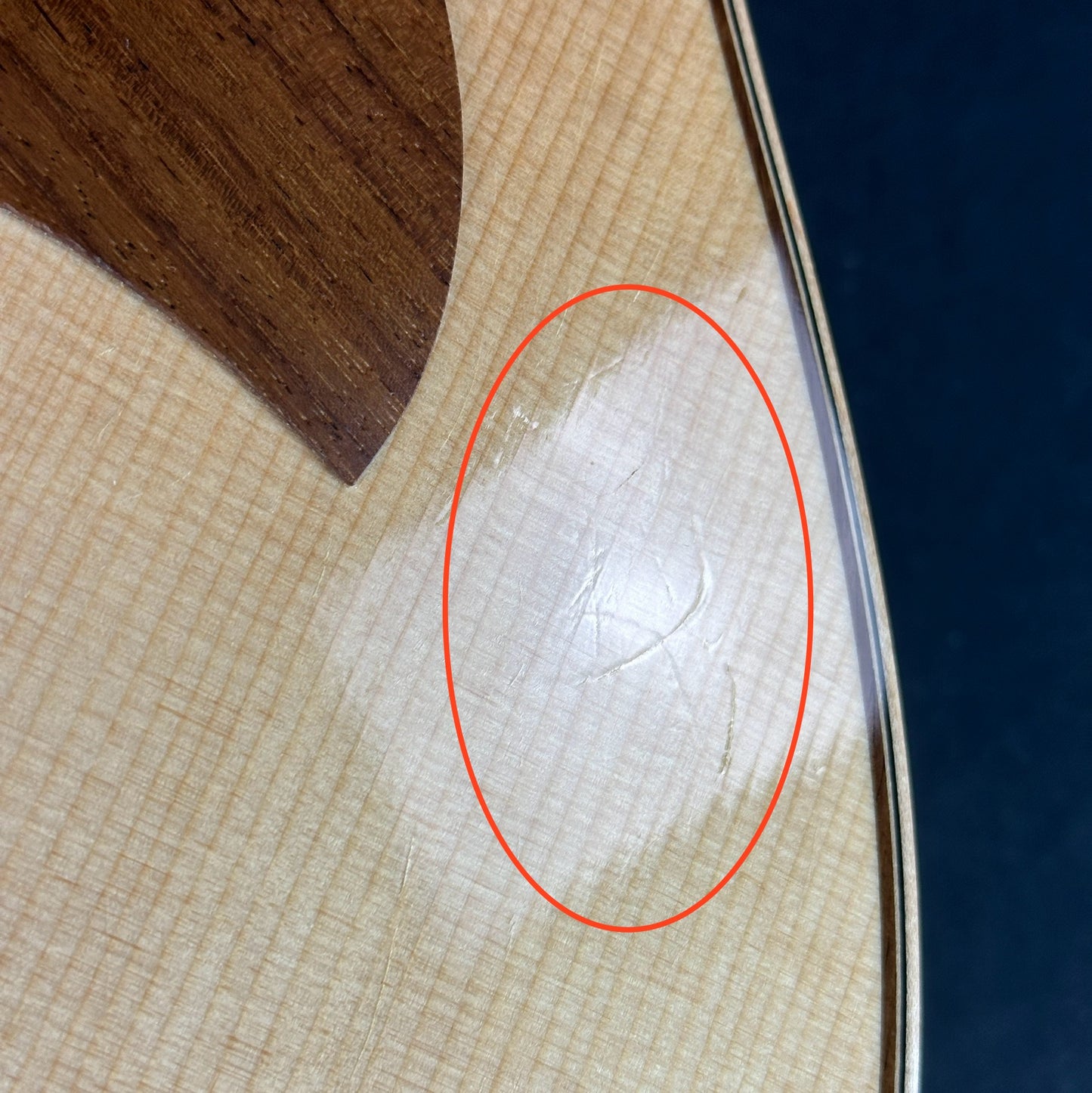 Scratches near pickguard of Used Taylor 856ce 12 String.