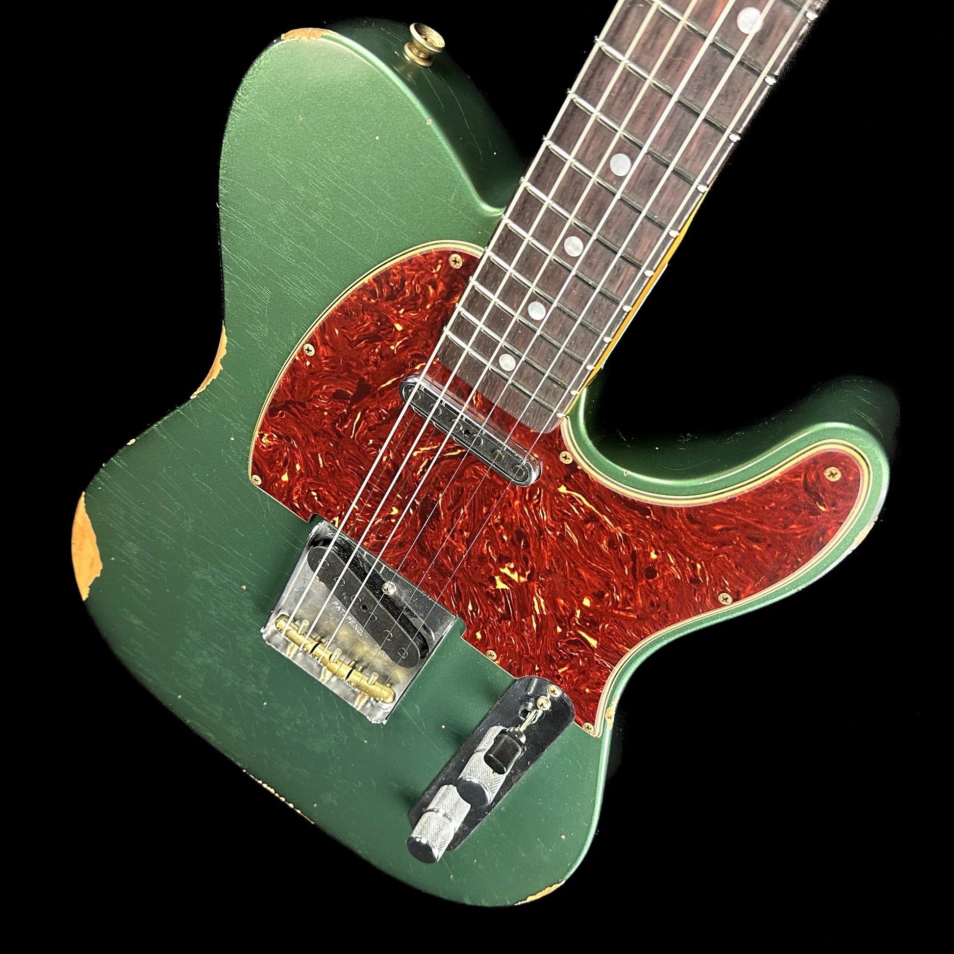 Front angle of Fender Custom Shop Limited Edition '64 Tele Relic Aged Sherwood Green Metallic.