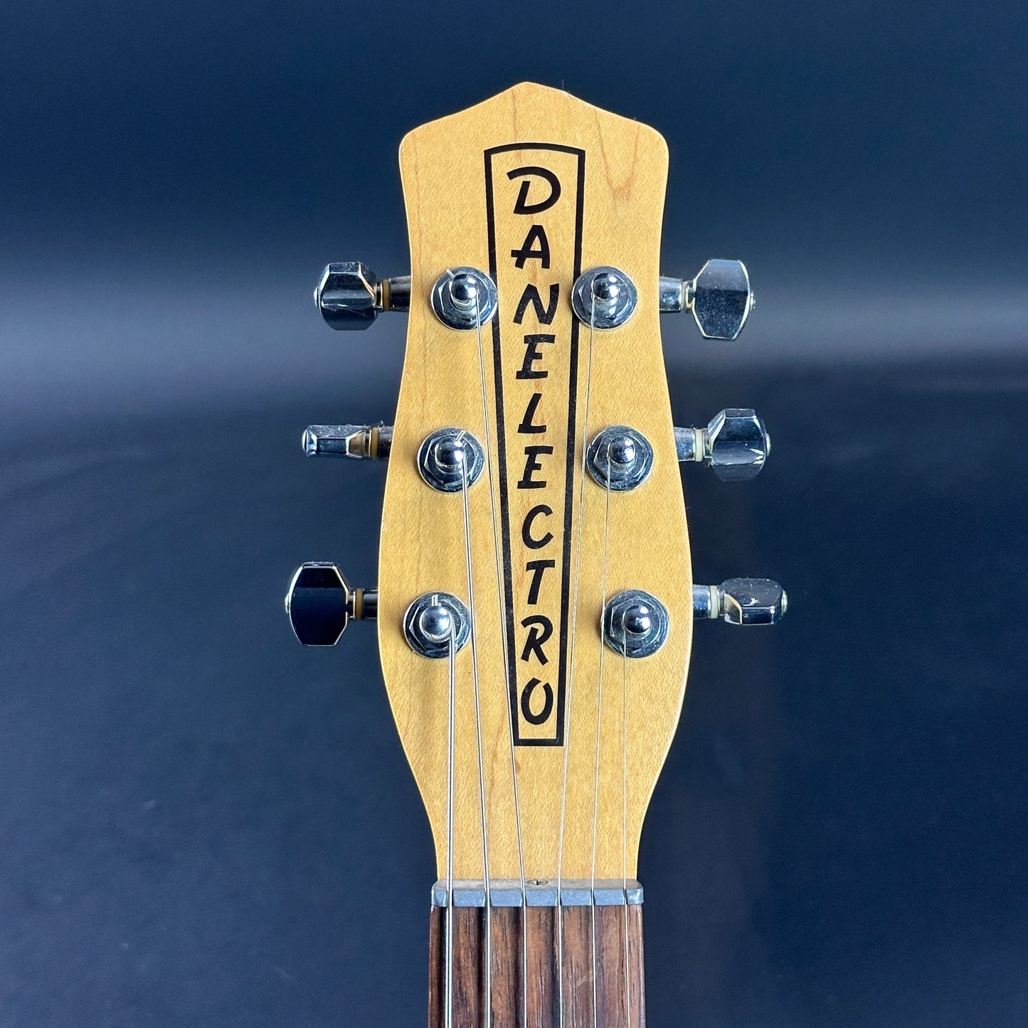 Front of headstock of Used Danelectro '56 U3 Green Sparkle.