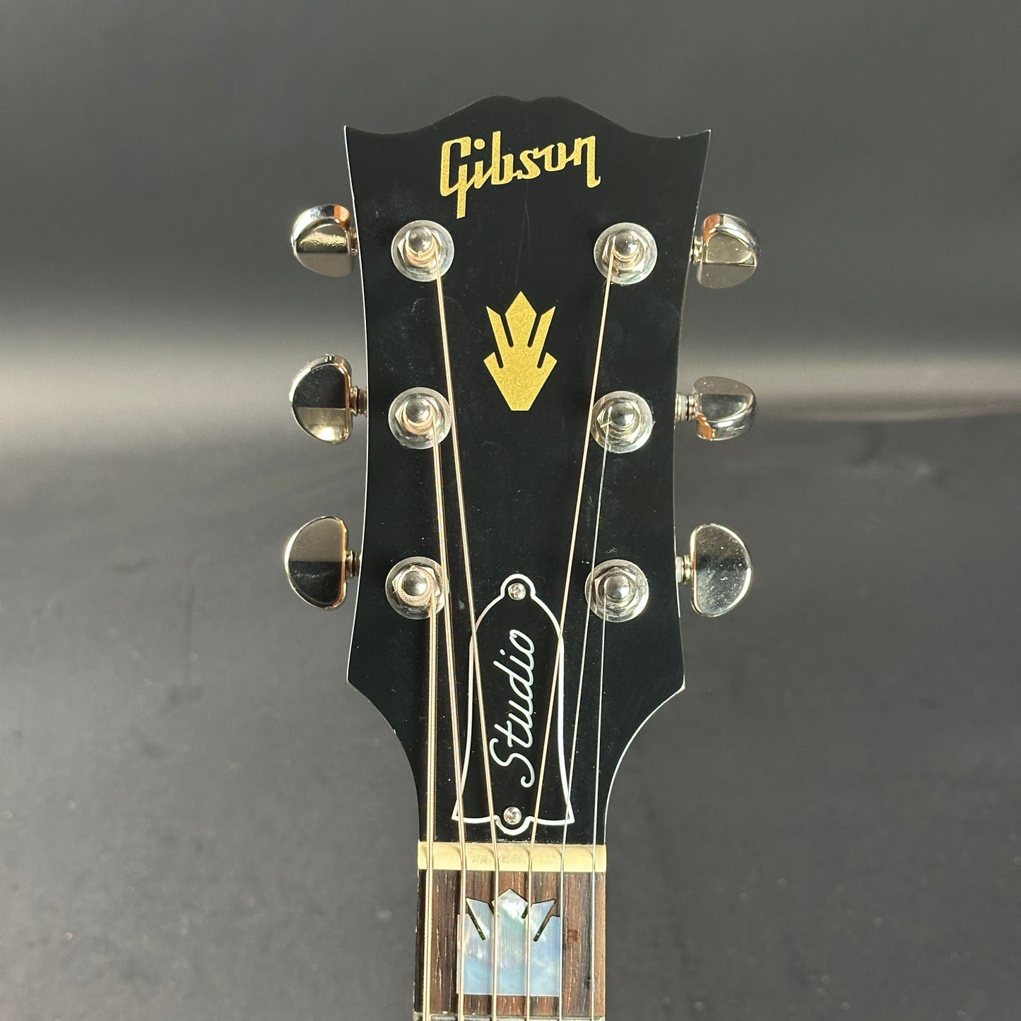 Front of headstock of Used Gibson SJ-200 Studio Rosewood Burst.