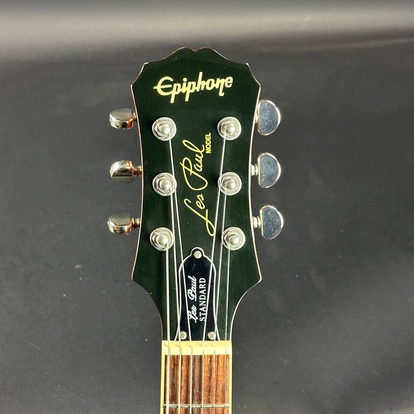 Front of headstock of Used Epiphone Les Paul Standard Honeyburst.