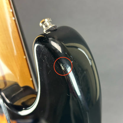 Ding on upper horn of Used Fender MIM Standard Strat Black.