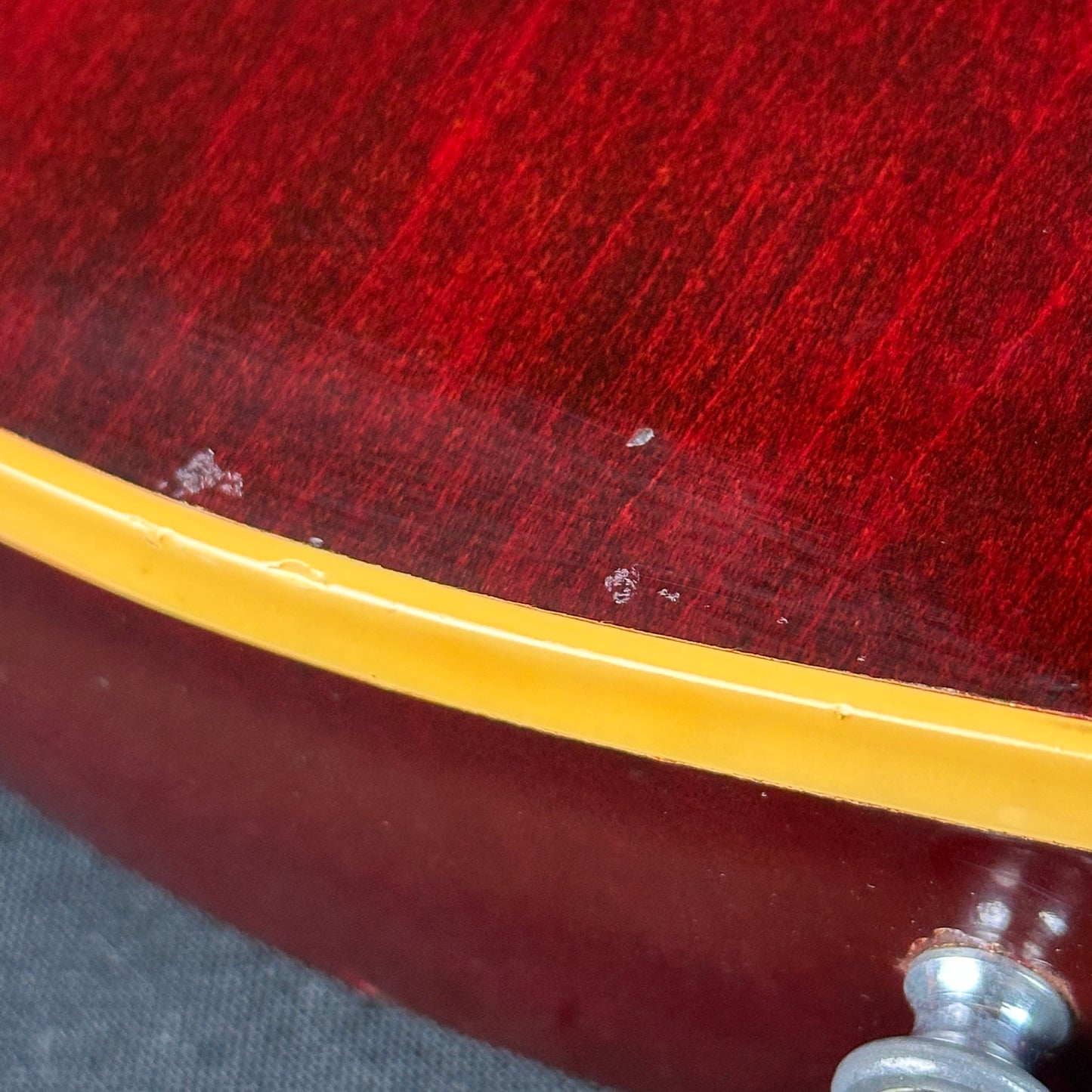 Damage near bottom strap button of Vintage 1977 Gibson Les Paul Standard Wine Red.