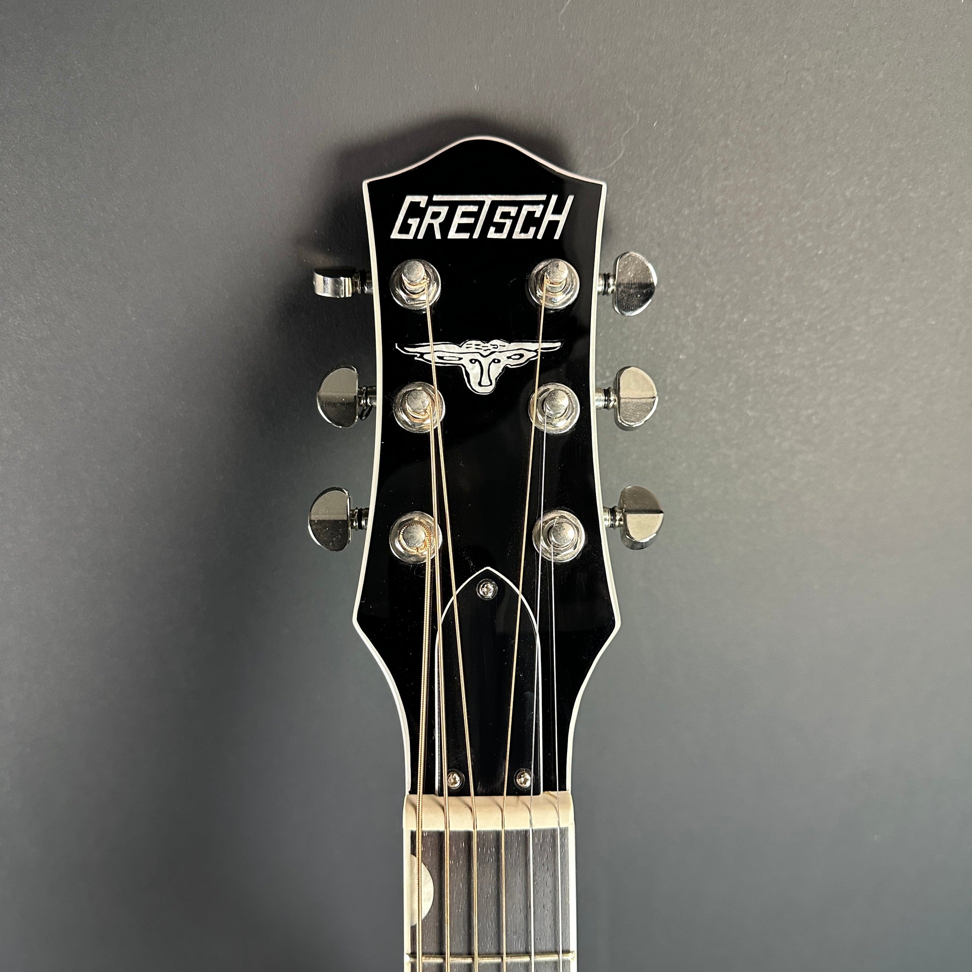 Front of headstock of Used Gretsch G5013CE Rancher Black.