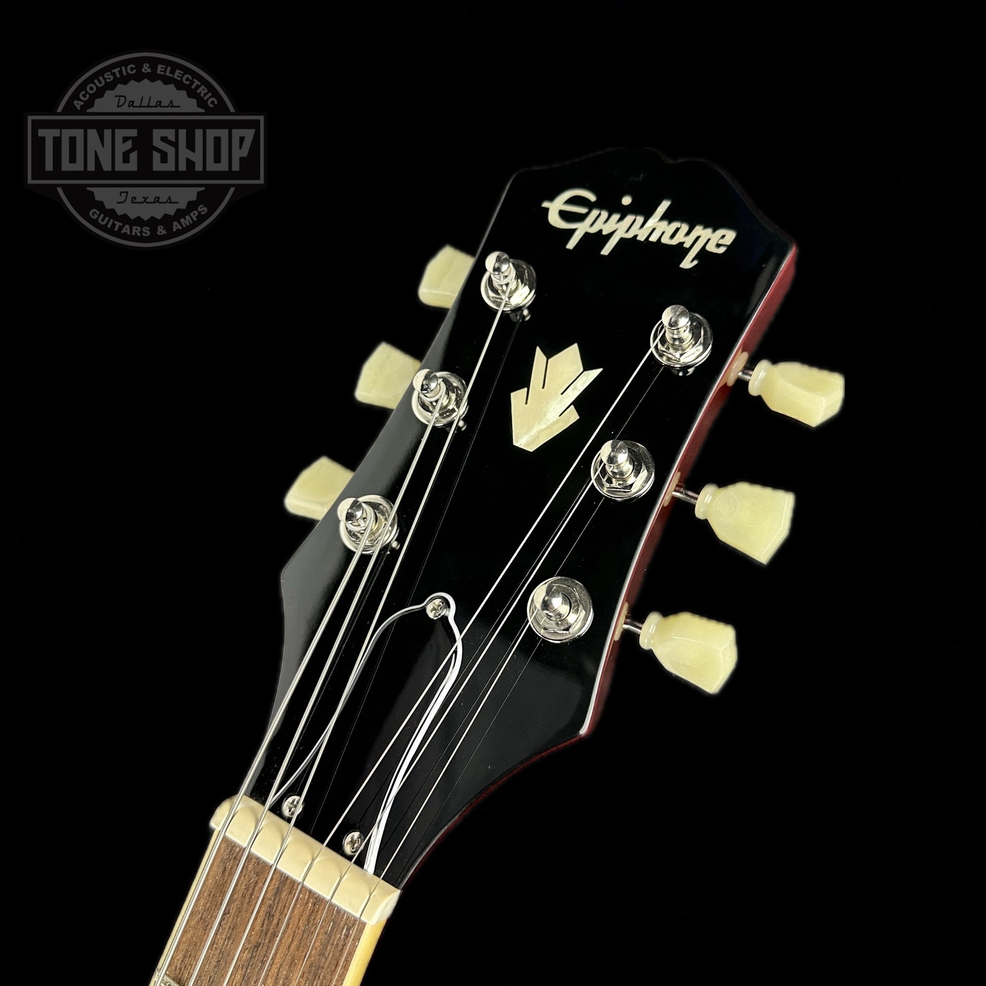 Front of headstock of Used Epiphone ES-335 Figured Limited Raspberry Burst.