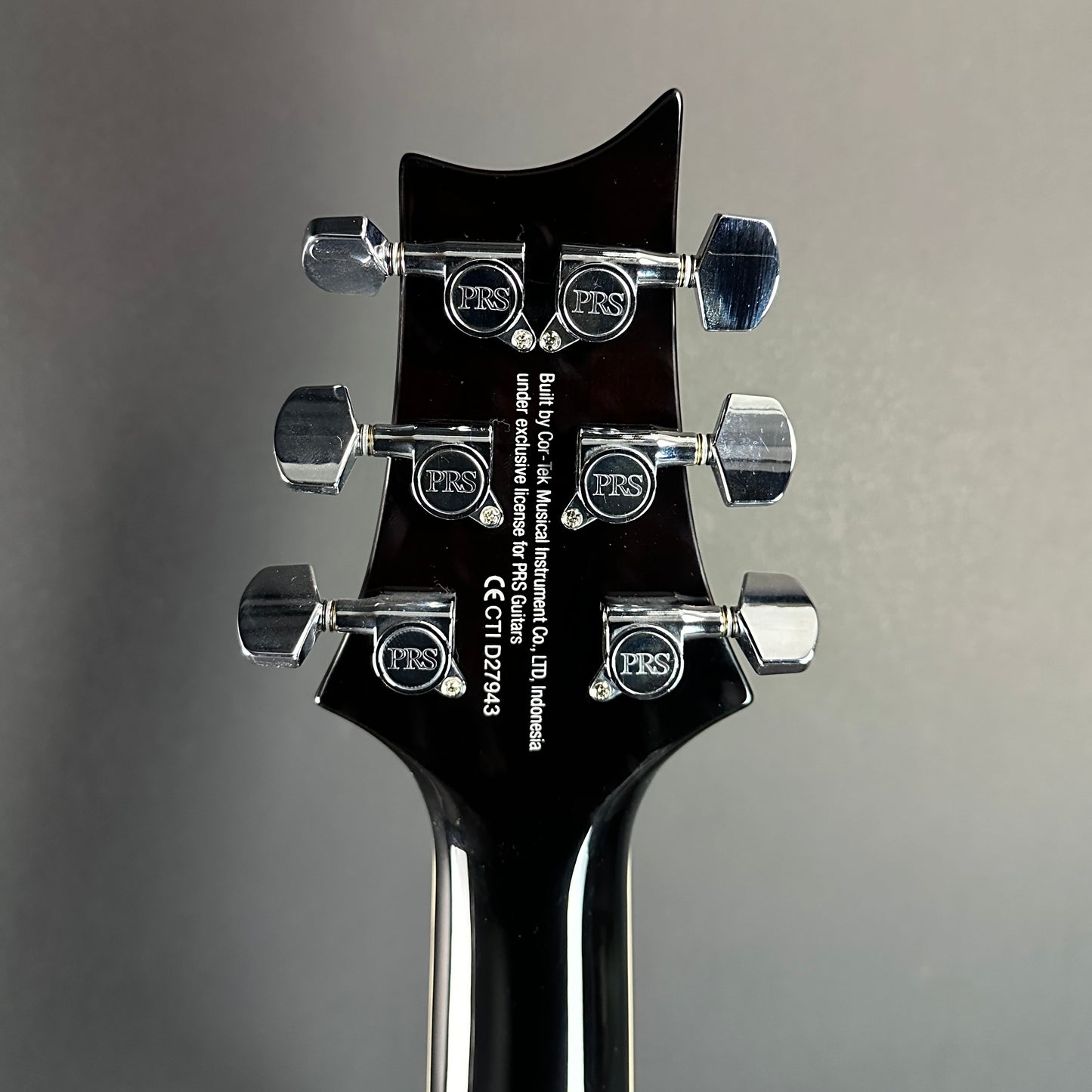 Back of headstock of Used PRS SE Custom 22 Semi-Hollow Black Gold Burst.