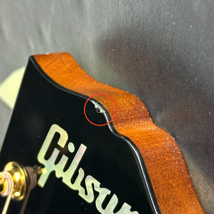 Chip on headstock of Used Gibson Custom Shop M2M Hummingbird Original Adi Red Spruce Top.