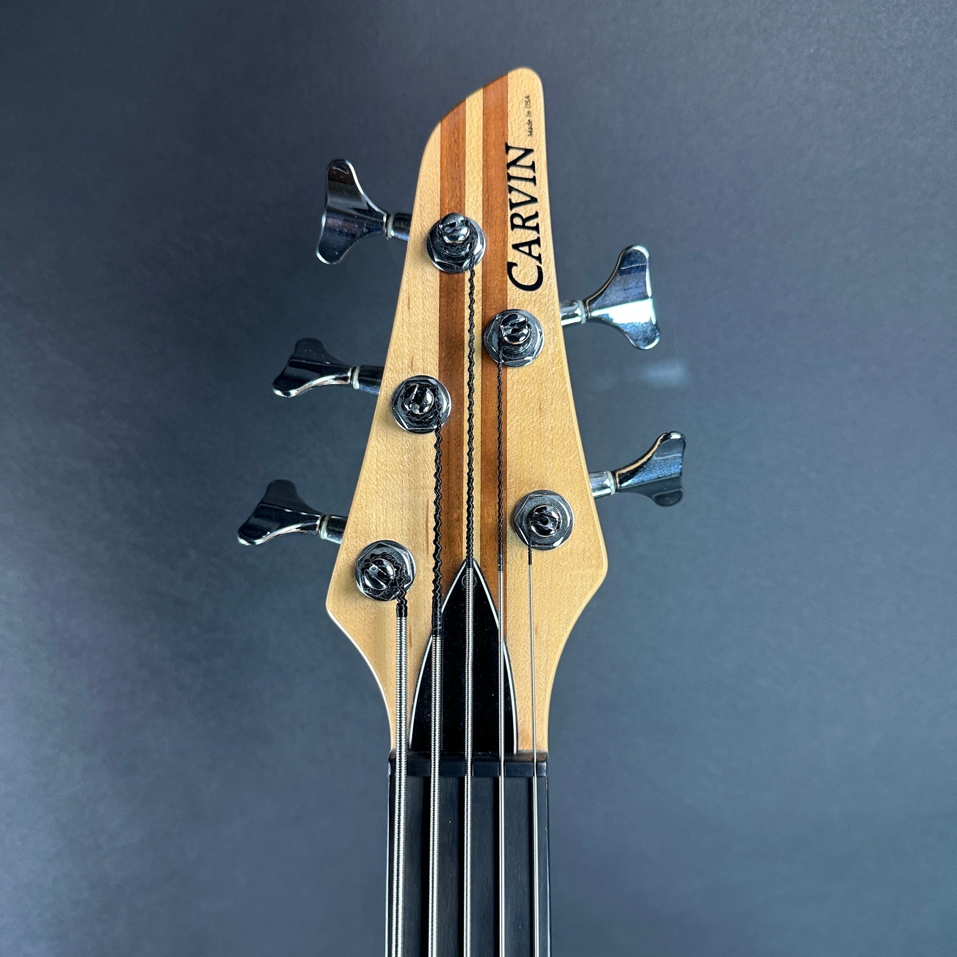 Front of headstock of Used Carvin LB75 Five String Fretless.