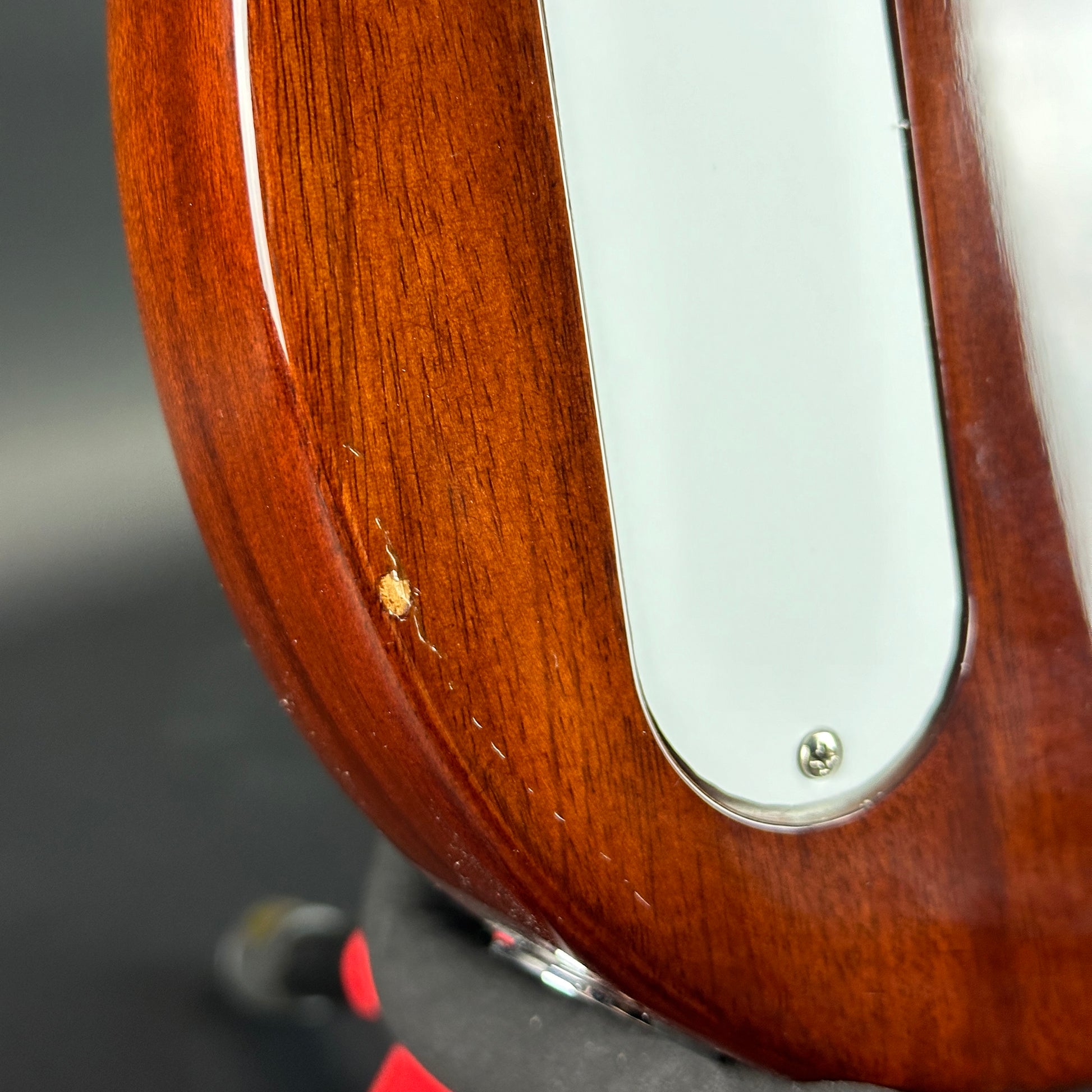 Ding on back of Used Harmony Juno Transparent Brown Flame Maple.