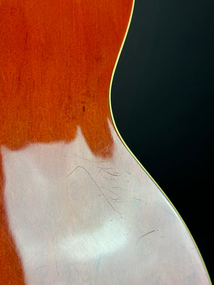 Scratches on back of Used 1991 Gretsch G6119B Broadcaster Bass Orange.