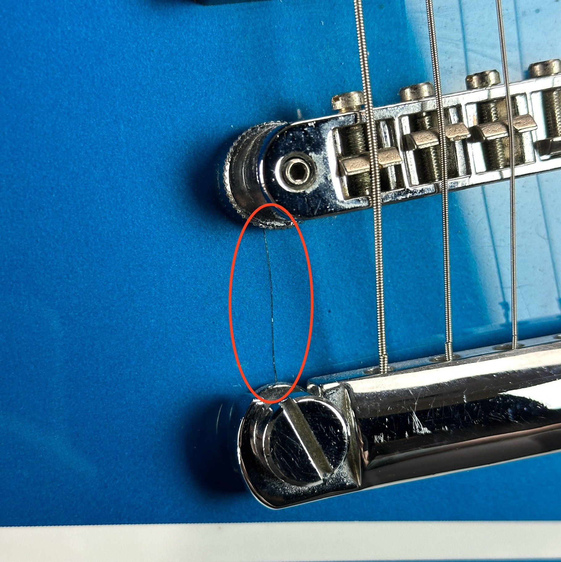 Crack near bridge of Used Fender Tornado GT HH Blue.