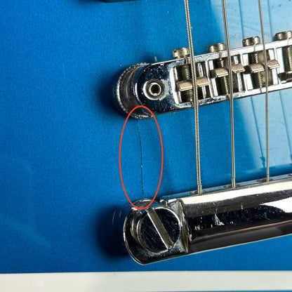 Crack near bridge of Used Fender Tornado GT HH Blue.