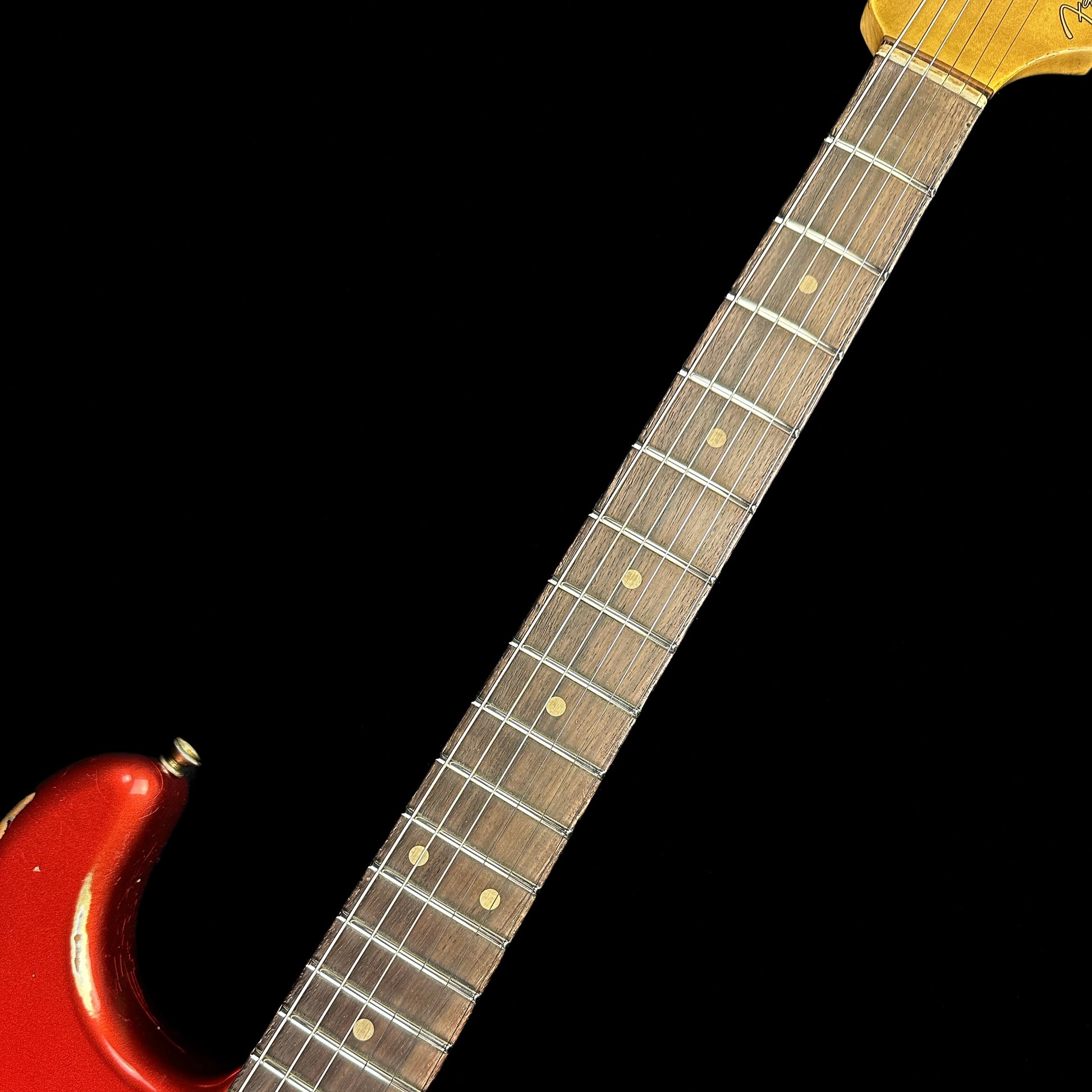 Fretboard of Fender Custom Shop 59 Strat Heavy Relic Super Faded Aged Candy Apple Red.