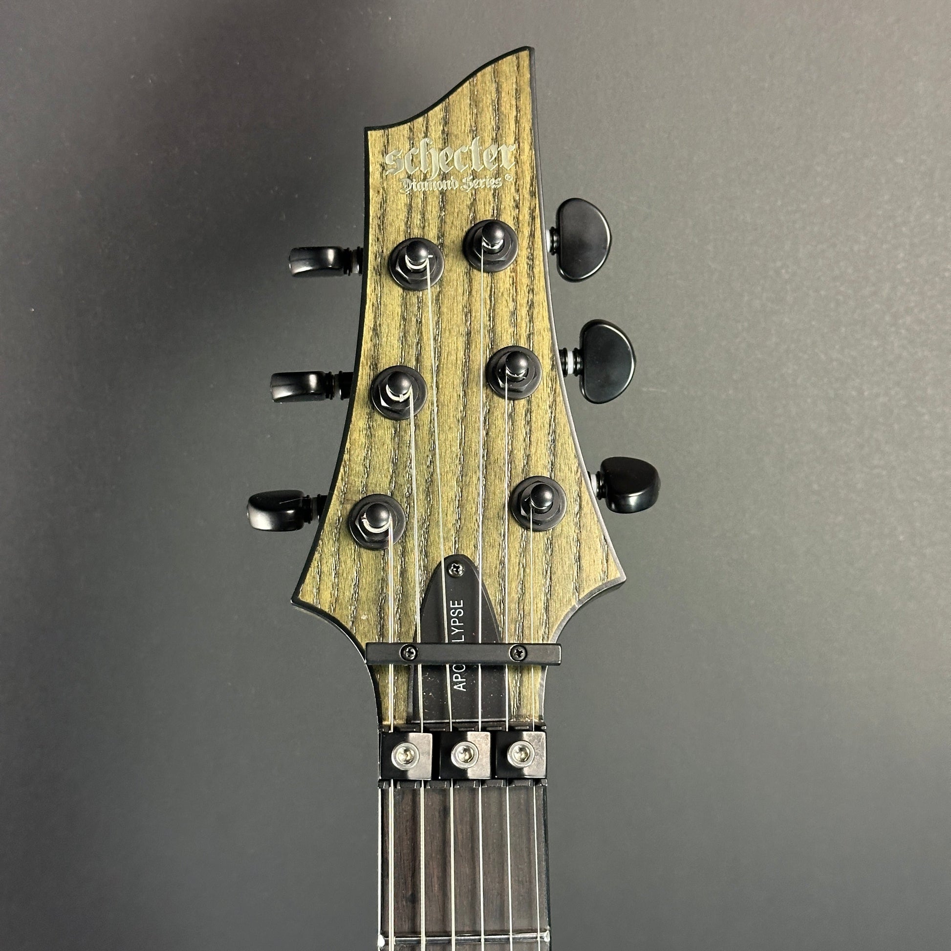 Front of headstock of Used Schecter C1 Apocalypse Ash Green Sustainer.